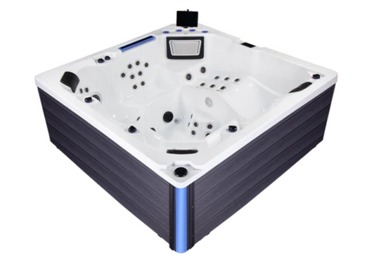 BuenoSpa Denver Hot Tub in white acrylic with dark gray cabinet and blue LED corner accent, featuring built-in jets, headrests, and an integrated tablet holder — tablet shown for display purposes only, not included with purchase.