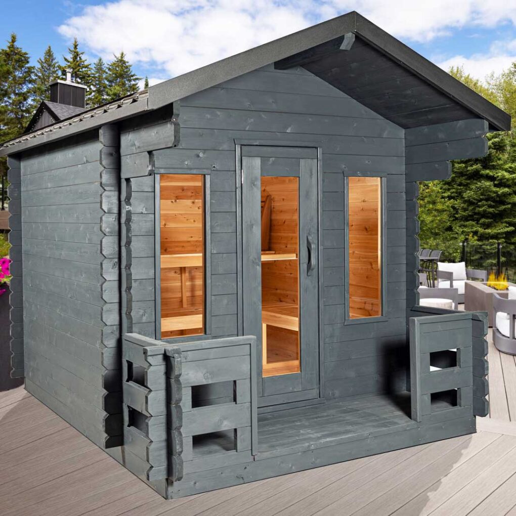 Grey-stained Canadian Timber Georgian outdoor sauna cabin with porch, glass door and windows, designed for backyard installation and cedar interior comfort.